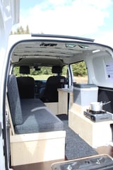 an interior view of the seating area and storage in the back of the nissan nv200